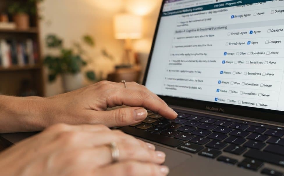 Personne qui lit de près le texte sur l’écran d’un ordinateur portable